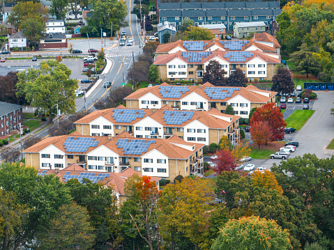 aerial view of community with solar panel installed on apartment building roof