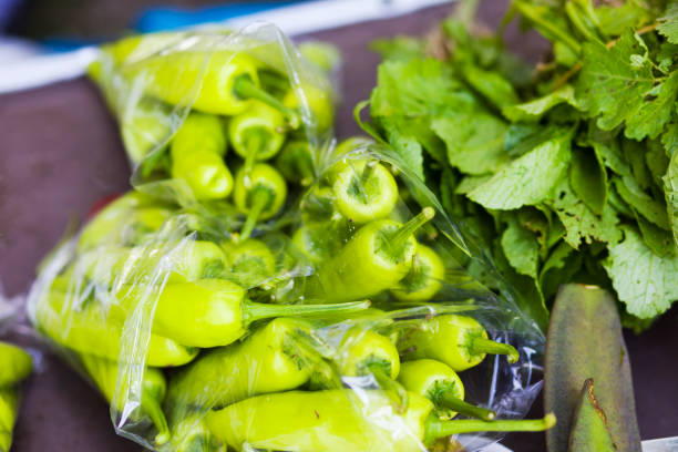 Mid seized green thai chili peppers at market stall in Chiang Rai province