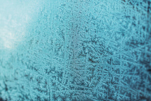 Ice background. Copy space. Frost pattern on glass. Cold weather.