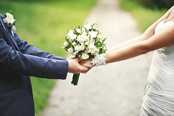 istock Newlywed couple holding hands outside on a walkway 181497965