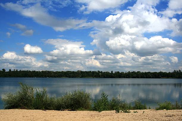 clouds over the lake a quarry pond in Germany leopoldshafen stock pictures, royalty-free photos & images