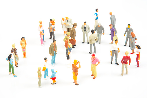 miniature people. group of different people communicate with each other on a white background. concept of communications and relations in society.