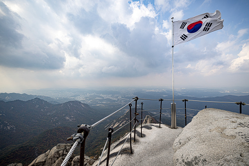 Gibraltar flag waving on the flagpole on a sky background