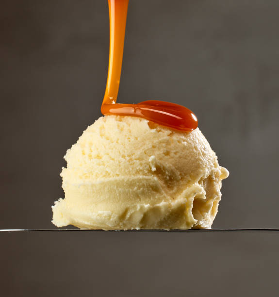 istock caramel sauce pouring on vanilla ice cream 1815001733