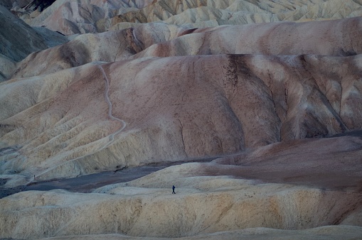 Hiker in the distance walking into the valley from Zabriskie Point
