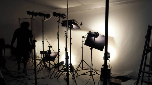 istock Studio lighting setup for photo shooting production with many equipment such as softbox, backdrop paper, white reflect foam and many more. 1815019308