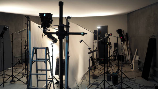 istock Studio lighting setup for photo shooting production with many equipment such as softbox, backdrop paper, white reflect foam and many more. 1815019311