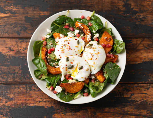 istock Roasted butternut squash salad served with poached eggs, spinach, nuts and pomegranate seeds 1815020353