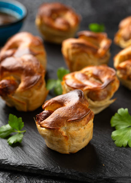 istock Mini Toad in the hole, Baked sausages in Yorkshire pudding with gravy 1815020861