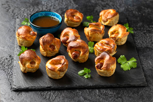 istock Mini Toad in the hole, Baked sausages in Yorkshire pudding with gravy 1815020866