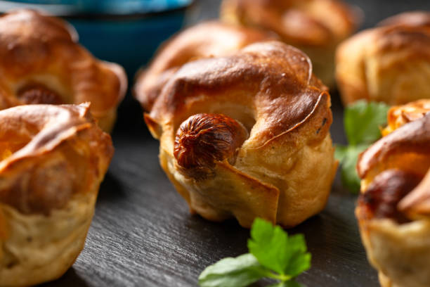 istock Mini Toad in the hole, Baked sausages in Yorkshire pudding with gravy 1815020877