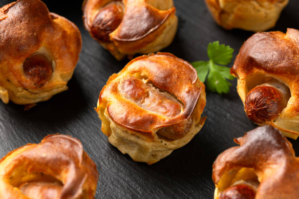 istock Mini Toad in the hole, Baked sausages in Yorkshire pudding with gravy 1815020887