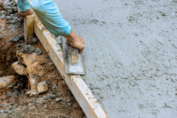 istock Leveling of new concrete pavement using a special working tool by mason worker at construction site 1815021974