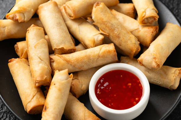 istock Fried vegetable spring rolls with sweet chilli sauce, party food 1815022529