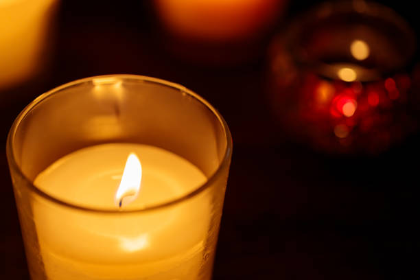 istock Yellow Candle Burning on Dark Background, Copy Space 1815033717