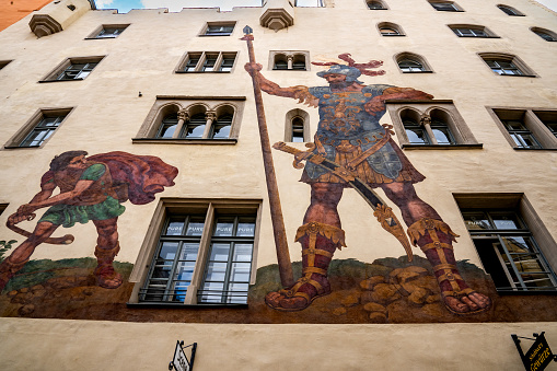 Regensburg, Bavaria, DE - June 5, 2023 Horizontal view of medieval Regensburgs Goliathstrasse (Goliath street) with its monumental mural of David versus Goliath.