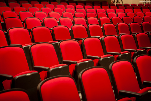 Red theater seats arranged in rows