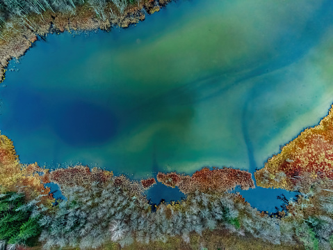 Aerial view of the lake in Lithuanian forests, wild autumn nature. Name of the lake 