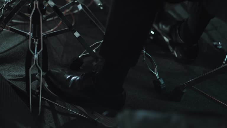 Close-up of the drummer's foot kicking on the bass pedal