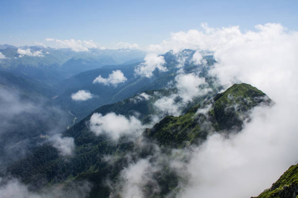 istock Dramatic landscape with mountain tops and white clouds 1815058006