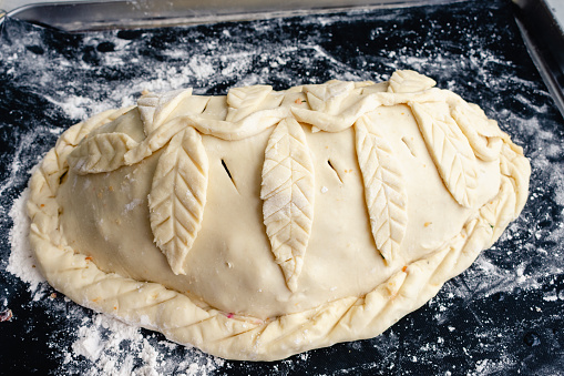 Turkey breast and stuffing wrapped in puff pastry decorated with pastry leaves