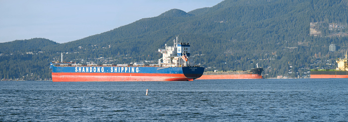 Panorama of ships in front of the coast of Vancouver as seen from Jericho Beach in British Columbia, Canada.