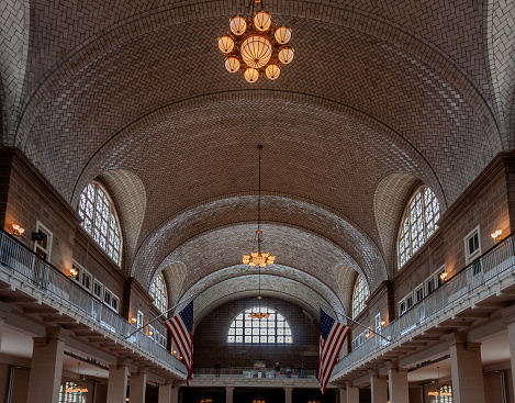 Inside view of Ellis Island National Museum of Immigration in New York City with the flag of the united states of america