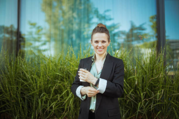 istock smiling modern woman worker near office building 1815088155