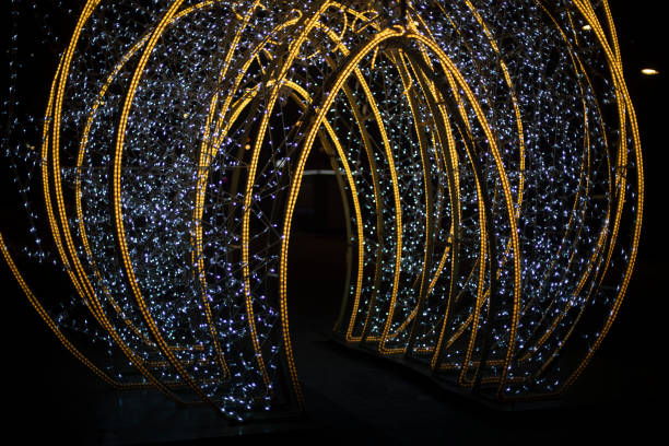 istock Garlands in dark. Bright light bulbs on black background. Decorating city during holidays. 1815089213