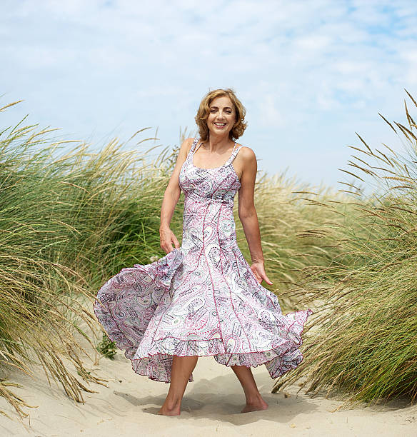 istock Attractive female dancing at the beach 181509978