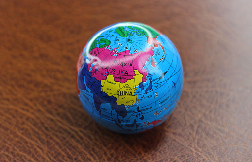 Model of Earth sphere on leather table closeup