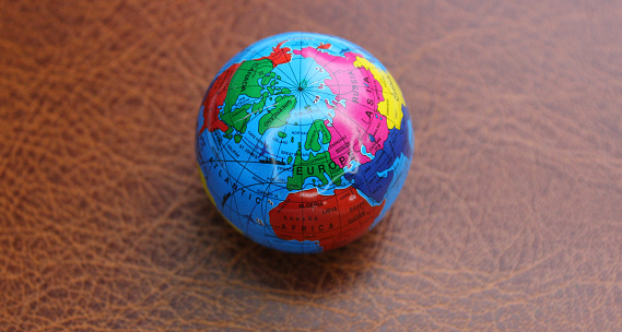 Small Round Globe  Lying On Leather Surface