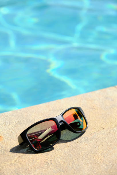 istock sunglasses on the background of the pool 1815106246