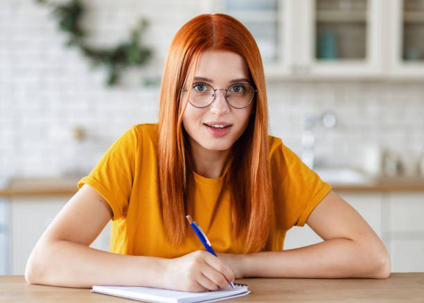 istock Online education distance learning Headshot young female student studying online at home 1815121977