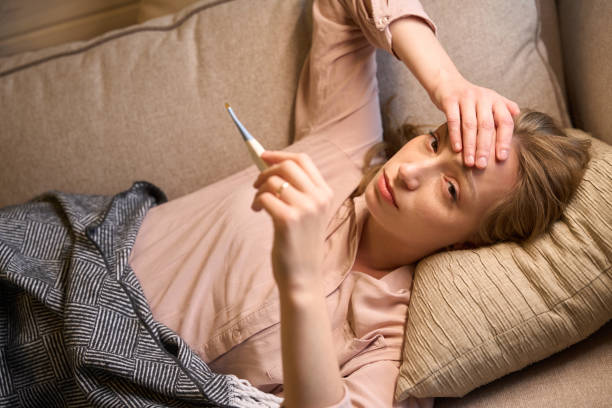 istock Lady having fever and measuring body temperature 1815129643
