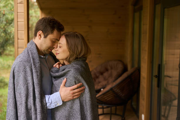 istock Lovely romantic couple hugging while standing on porch 1815129904