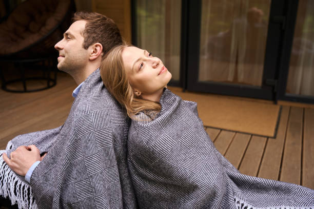 istock Smiling man and his beautiful wife sitting on doorstep 1815130175