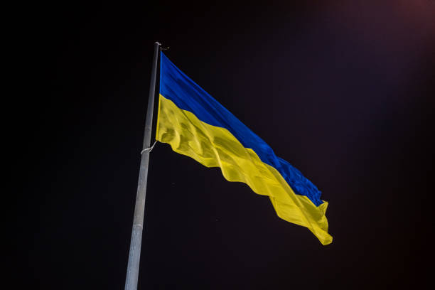 istock Ukrainian national official flag blowing on night sky background 1815152693