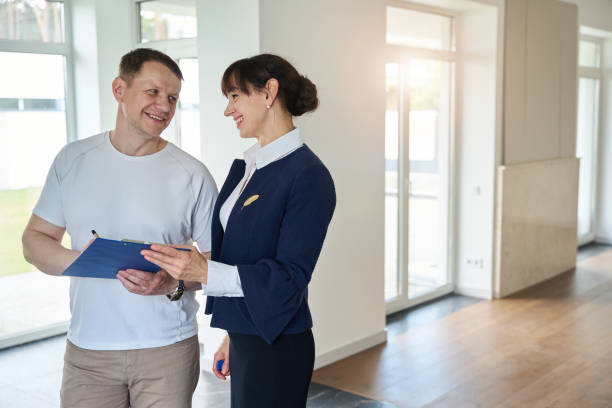 istock Satisfied buyer signs documents for purchasing a house 1815168702