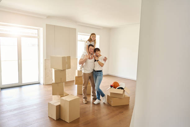 istock Married couple and their daughter are standing in empty room 1815168965