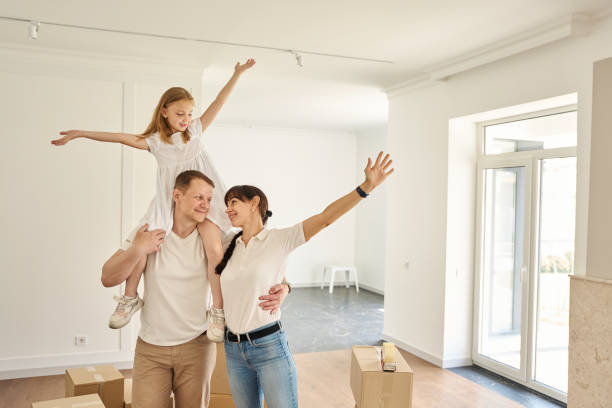 istock Parents play with their child in middle of spacious empty room 1815169280