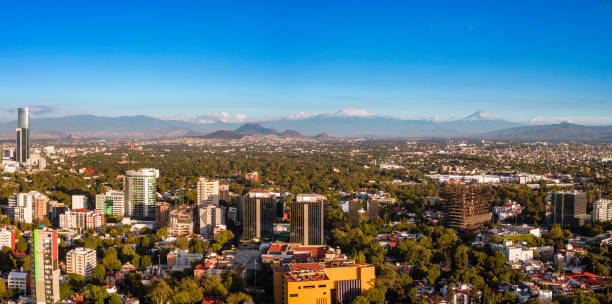 istock Cityscape with snowcapped volcanoes 1815170904