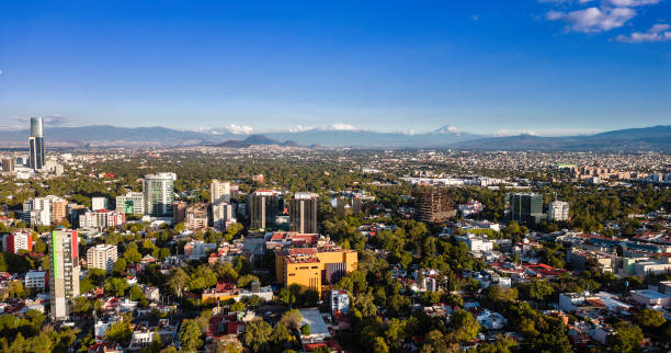 istock Cityscape with snowcapped volcanoes 1815171419