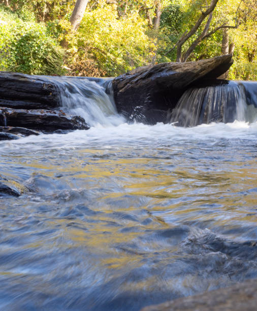 istock Low Angle View of a Small Waterfall Over Large Flat Rocks 1815201160