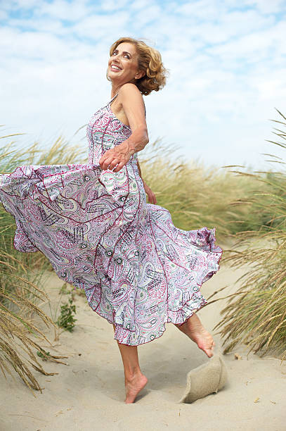 istock Active older woman dancing at the beach 181520735
