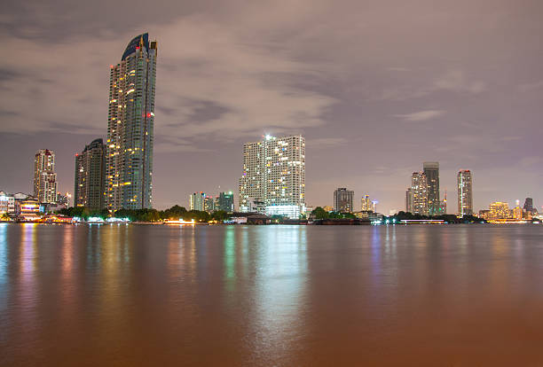 istock city downtown at night with building reflection in the river. 181520862