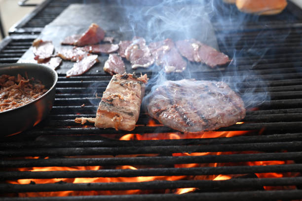 istock meat roasting on a charcoal barbecue lit wood with fire for roasting pork pancetta on the grill 1815219172