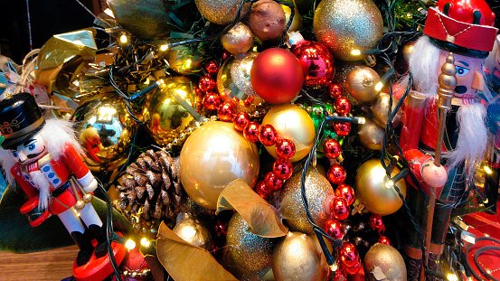 Christmas decorations, multicolored bright balls, toy soldiers, beads background. Close-up view.