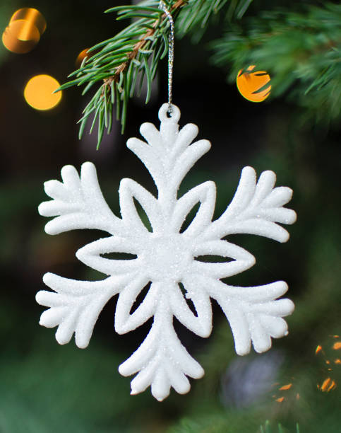 istock Christmas white snowflake hanging on christmas tree with light effect. 1815238644