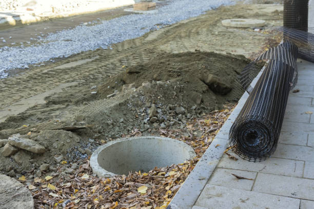 istock Earthworks construction to collect wastewater breaking asphalt a road 1815241287